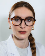 Flora Ecaille eyeglasses — round frame, worn by a woman
