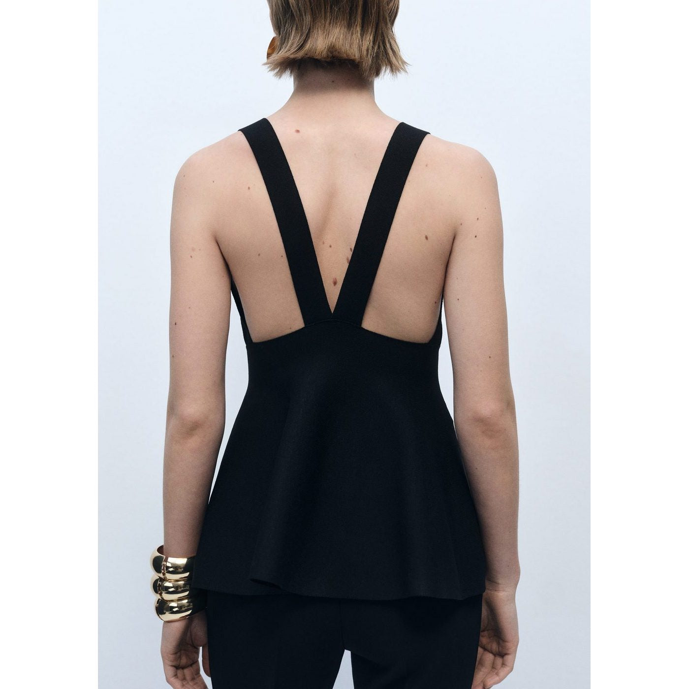 Top de punto fino con peplum