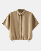 Beige women's shirt in fluid fabric with loose fit, classic collar and hem tightened by an adjustable drawstring.