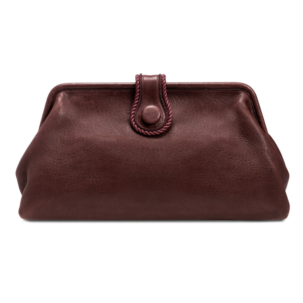Burgundy in a shade of dark cherry leather handbag with a rope closure on a white background