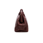 Burgundy in a shade of dark cherry leather handbag with a rope closure on a white background