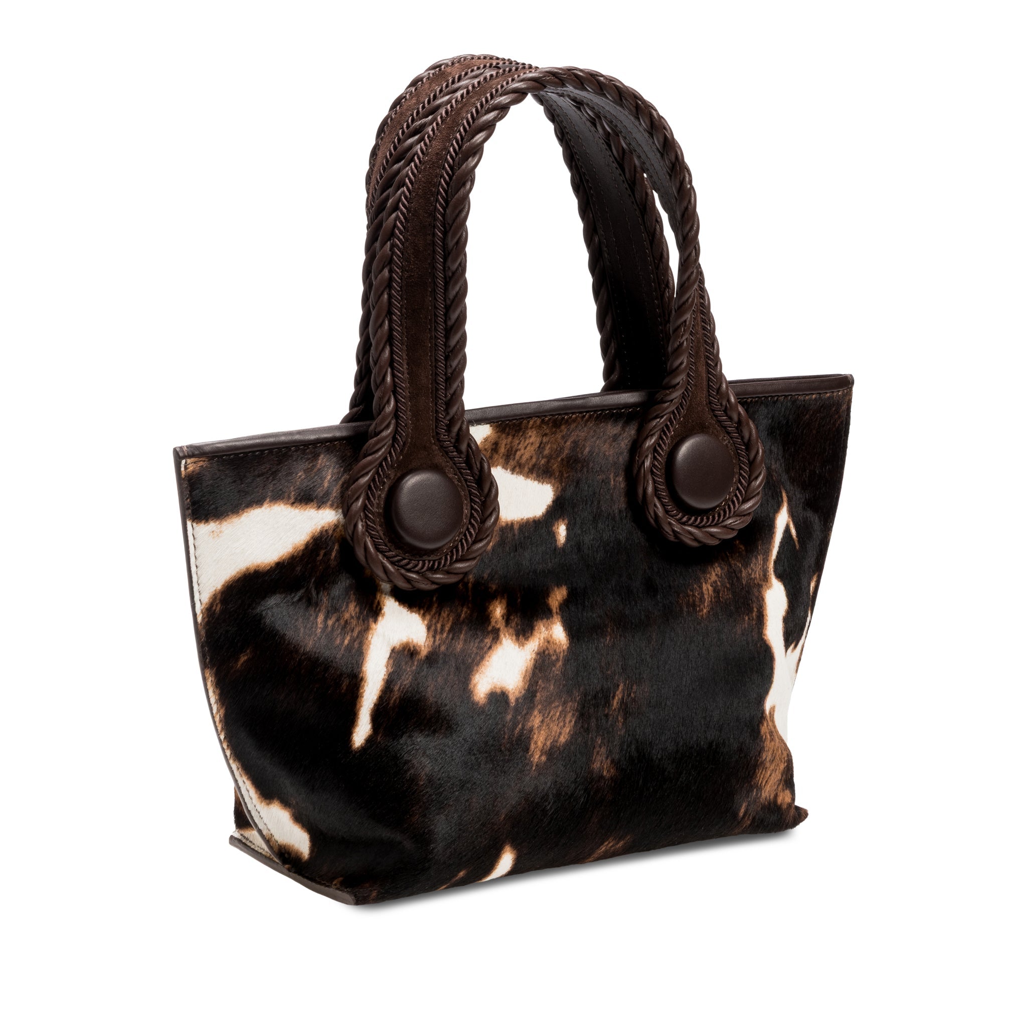 Dark brown and cream cow print pattern small tote bag with dark brown rope handles on a white background.