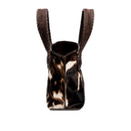 Dark brown and cream cow print pattern small tote bag with open dark brown rope handles on a white background, shown from the side.