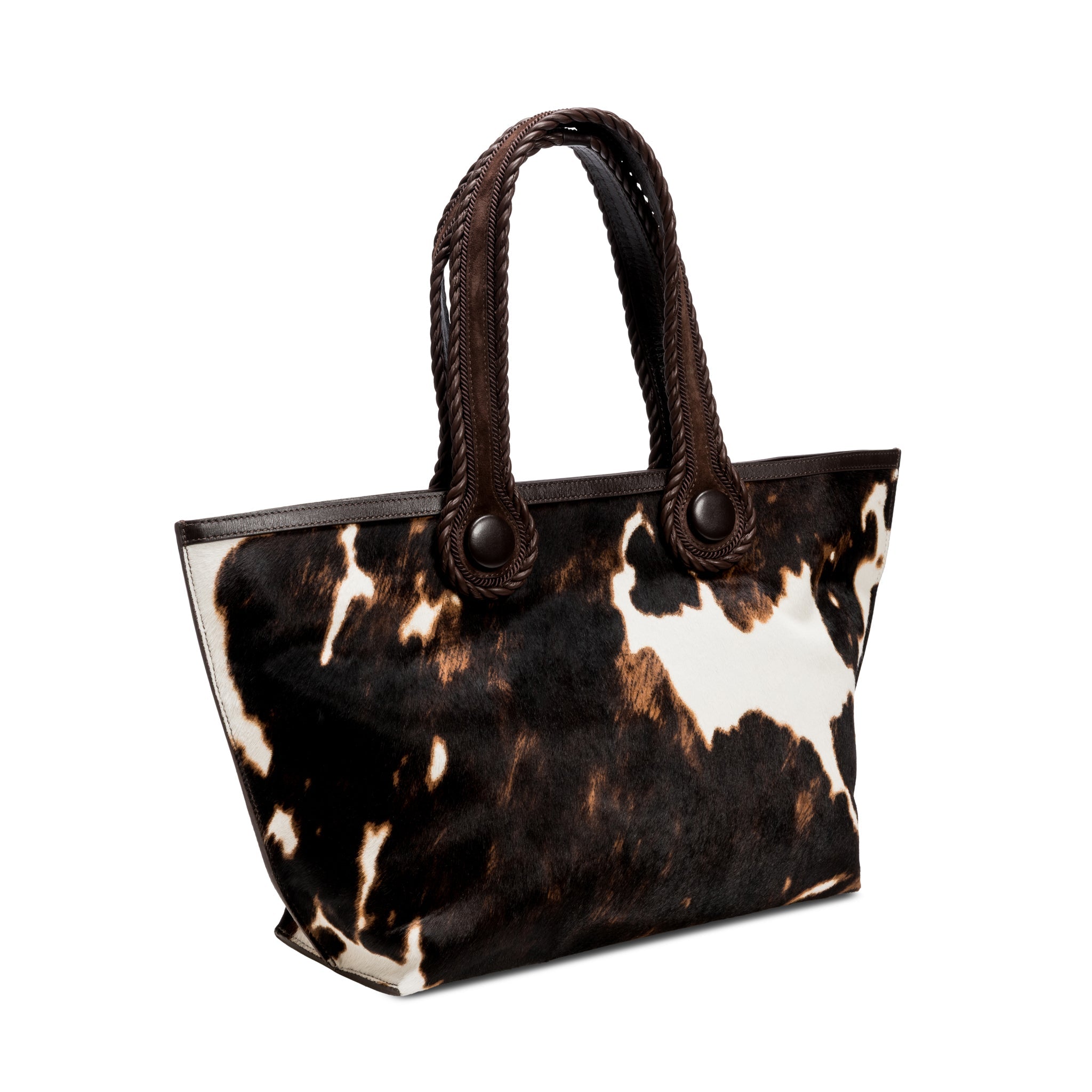 Dark brown and cream cow print pattern tote bag with dark brown rope handles on a white background.