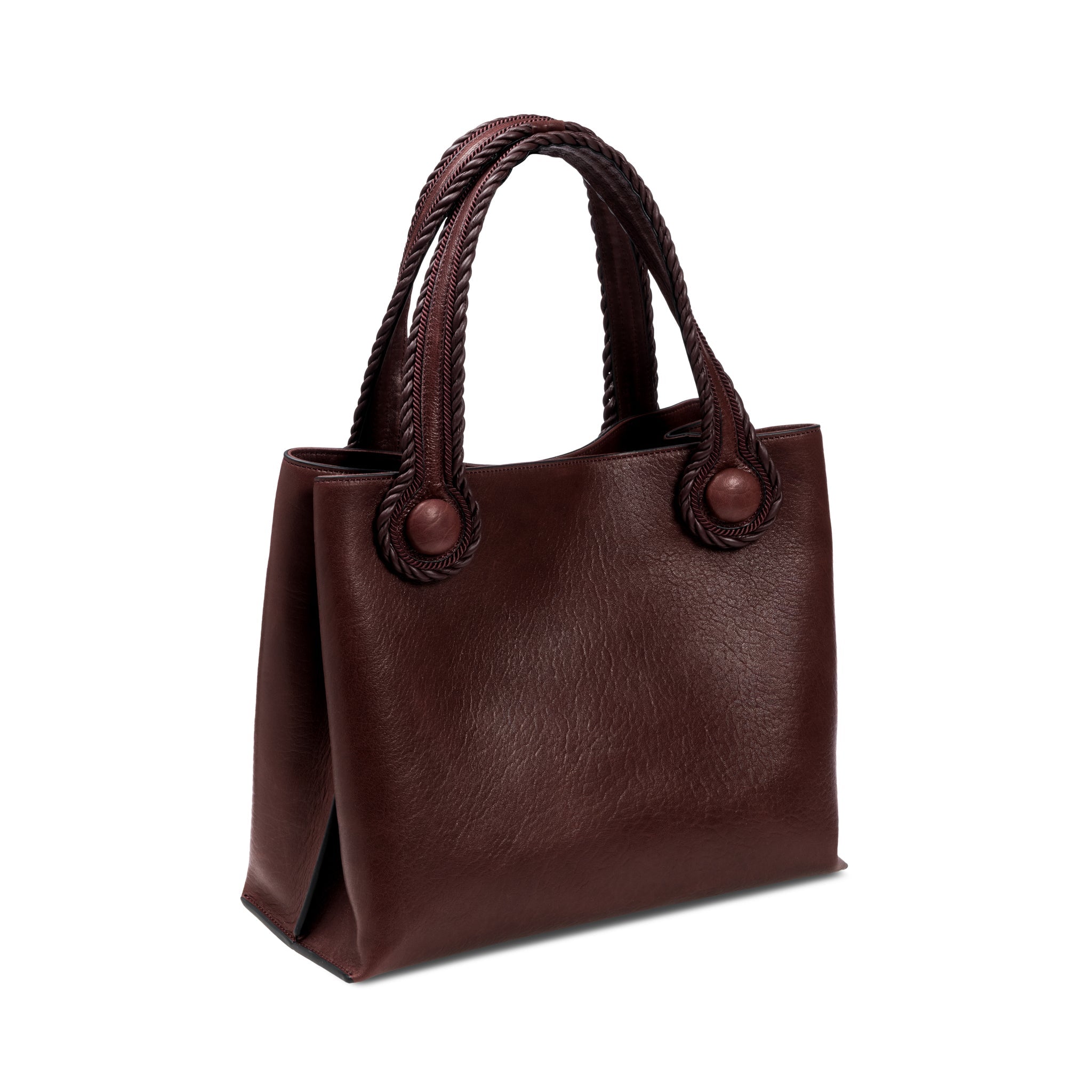 Burgundy leather in a shade of dark cherry tote bag with rope handles on a white background. When the inner straps are joined, the bag takes on a more rounded shape.