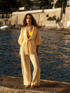 Beach set of June women's fluid pants and a Gilda Tatiane de Freitas beach top - high waist that lengthens a silhouette, wide legs, sensual summer look, chic Lyon beach pants, long neck tie blouse, long elastic sleeves, "Eternal Summer Spirit" printed stripes, light airy fluid material, French brand Lyon

