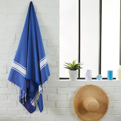 Woman using a Classic Customizable Ocean Blue Fouta - BY FOUTAS