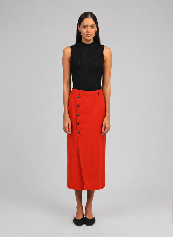 An'ge – Gaella Midi Skirt Chilli, model wearing a red skirt and a black top, front view