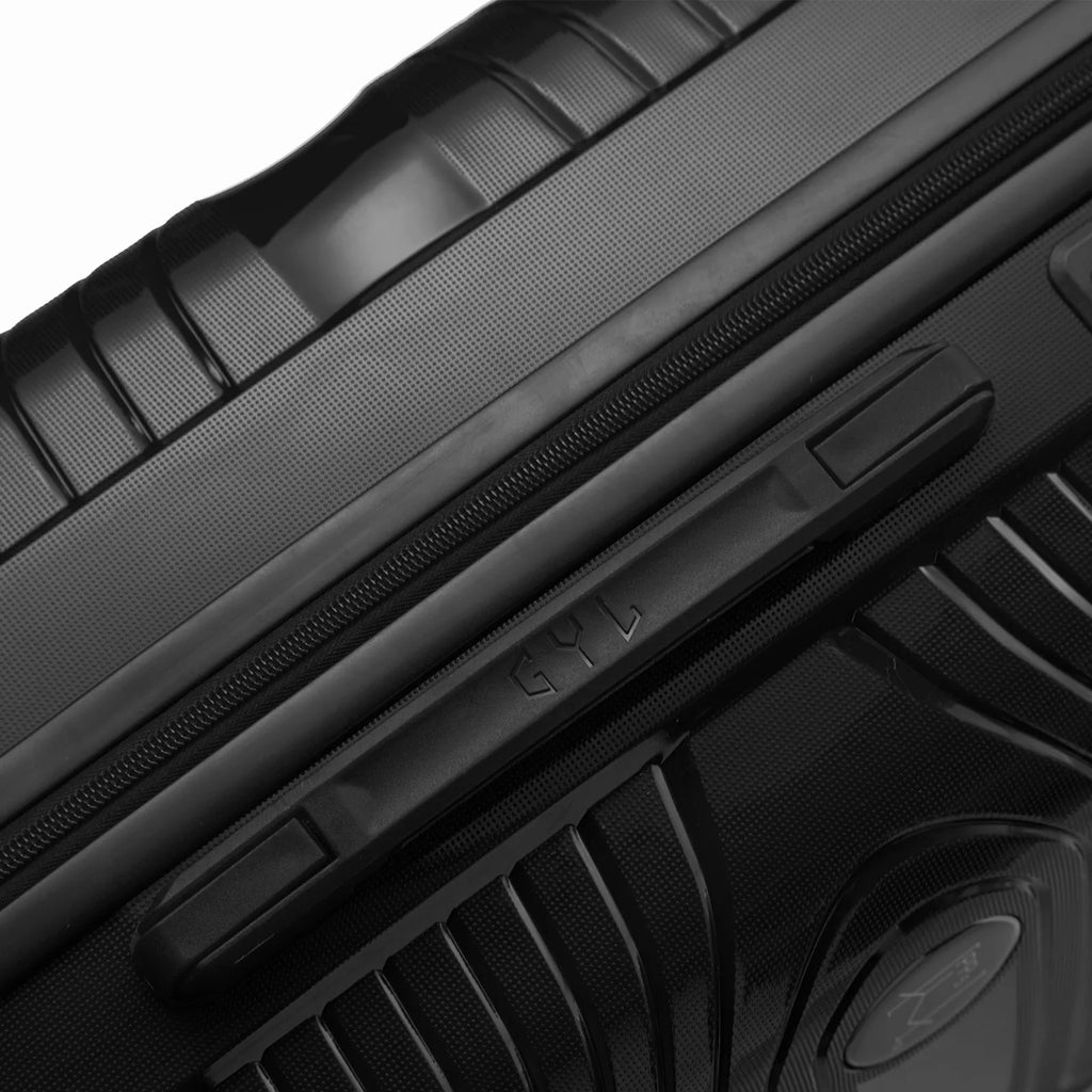 Detalle del asa lateral y del logo GYL en la maleta Signature roja. #couleur_noir