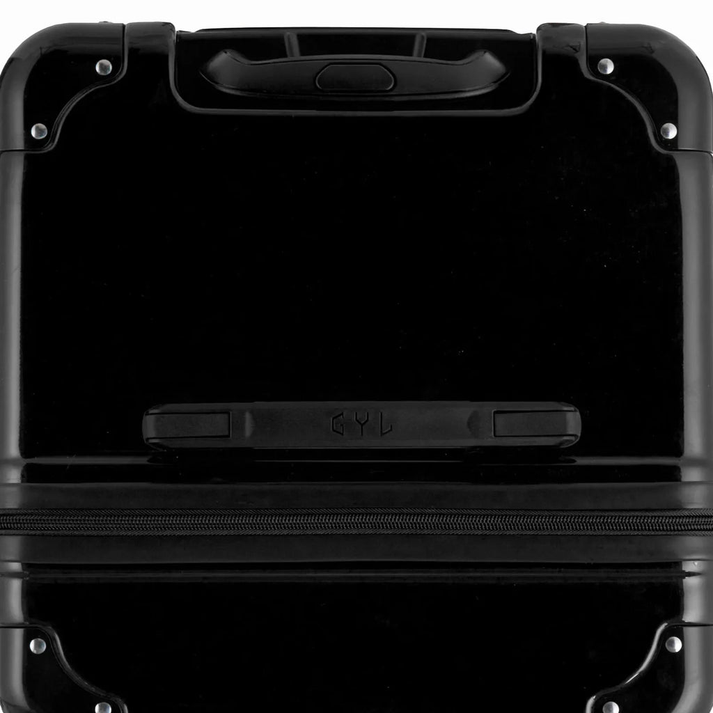 Top view of the GYL trunk suitcase in black polycarbonate, with central handle and reinforced corners. #couleur_noir