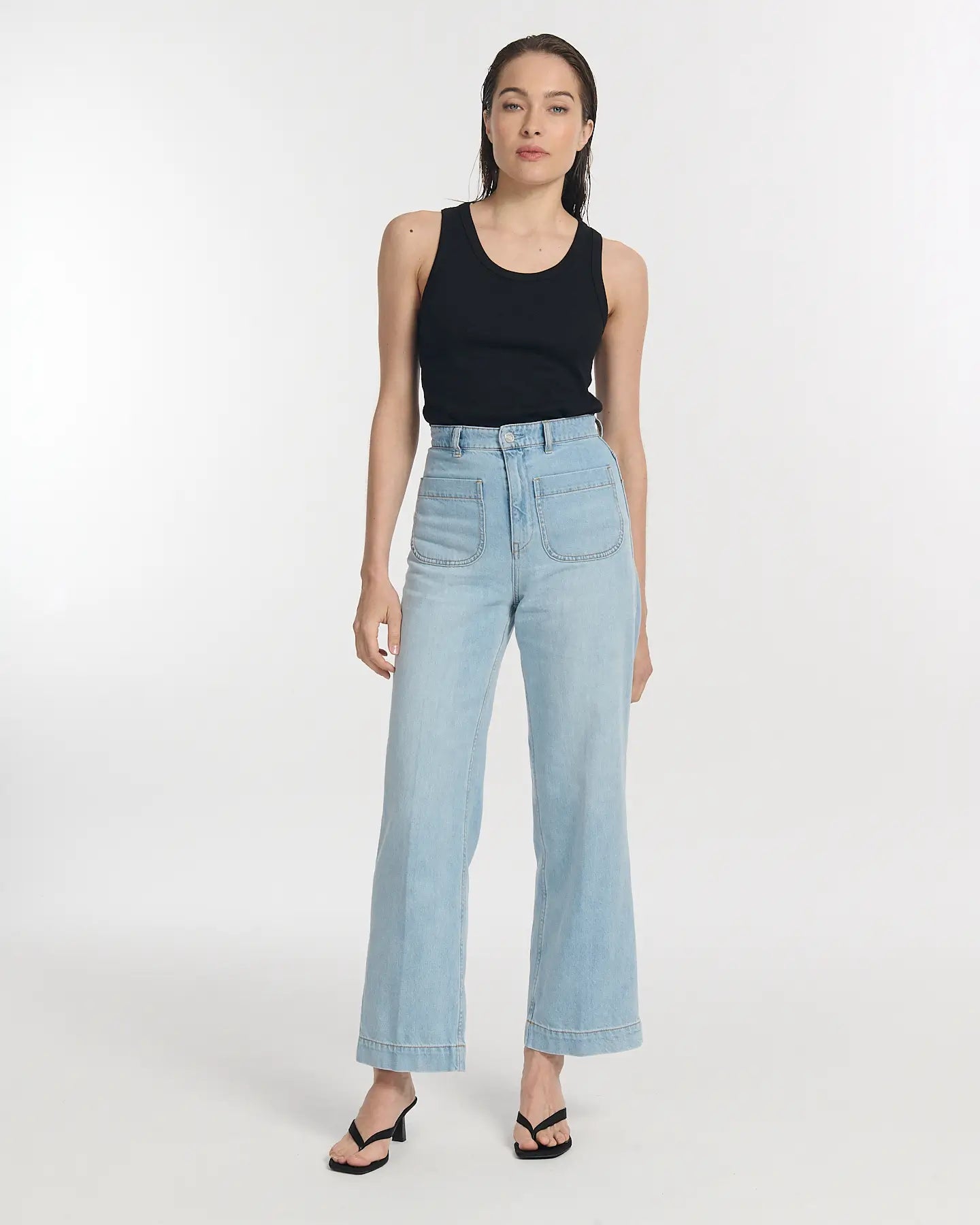 Women's jeans in light blue denim, wide, straight cut with high waist and front patch pockets, offering a casual and comfortable style.