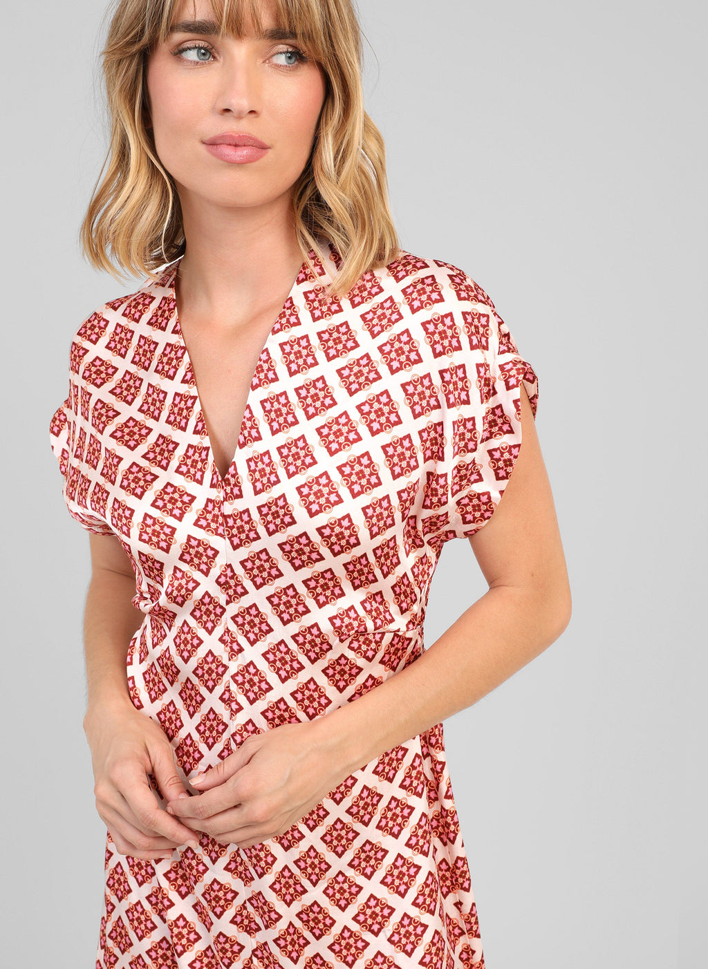 An'ge – Maurane Pirimini Ecru Midi Dress, model wearing a shirt dress with red and white geometric patterns