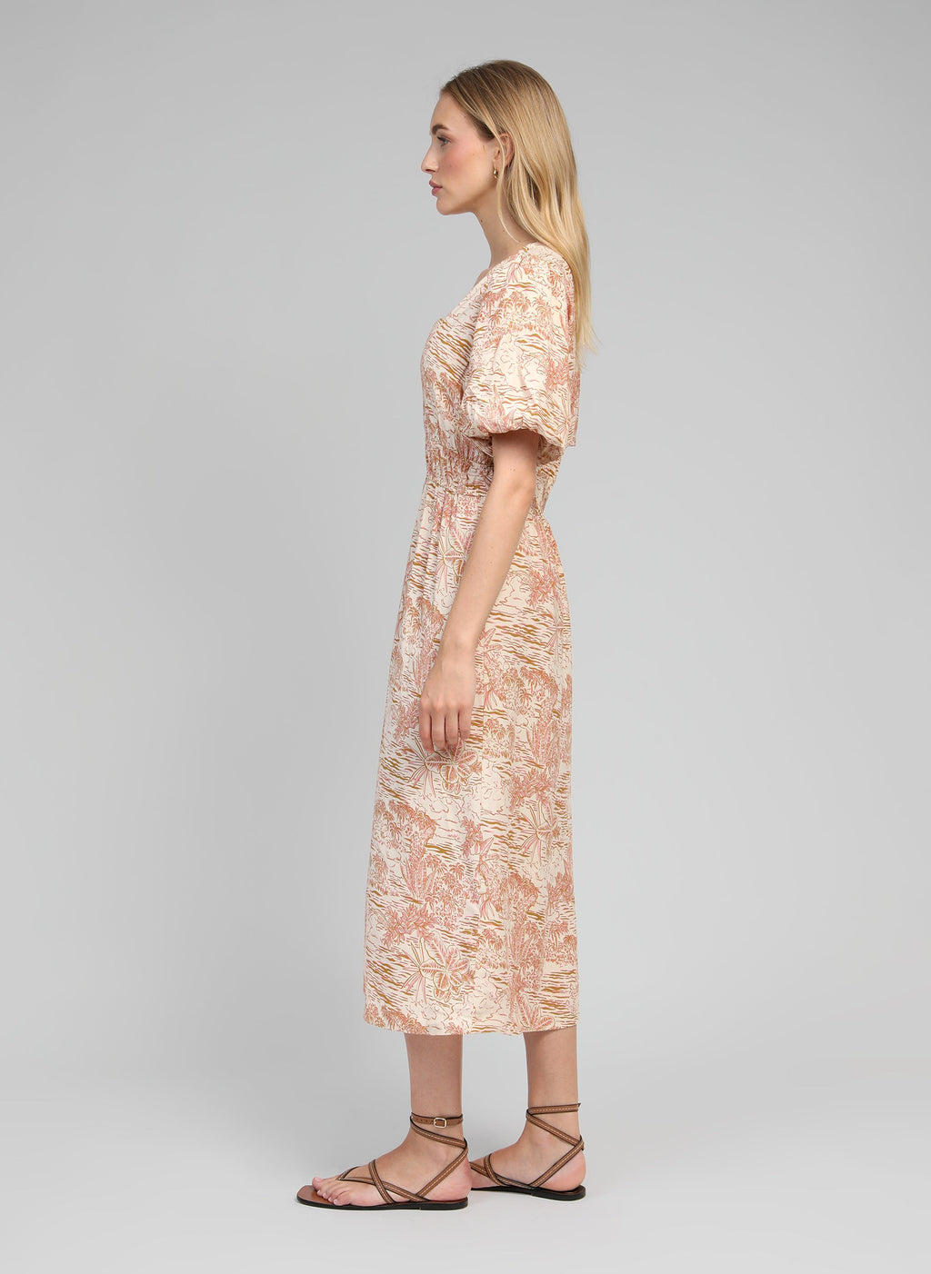 An'ge – Robe Longue Melila Josas Ocre, side view of blonde female model wearing a beige and pink printed maxi dress