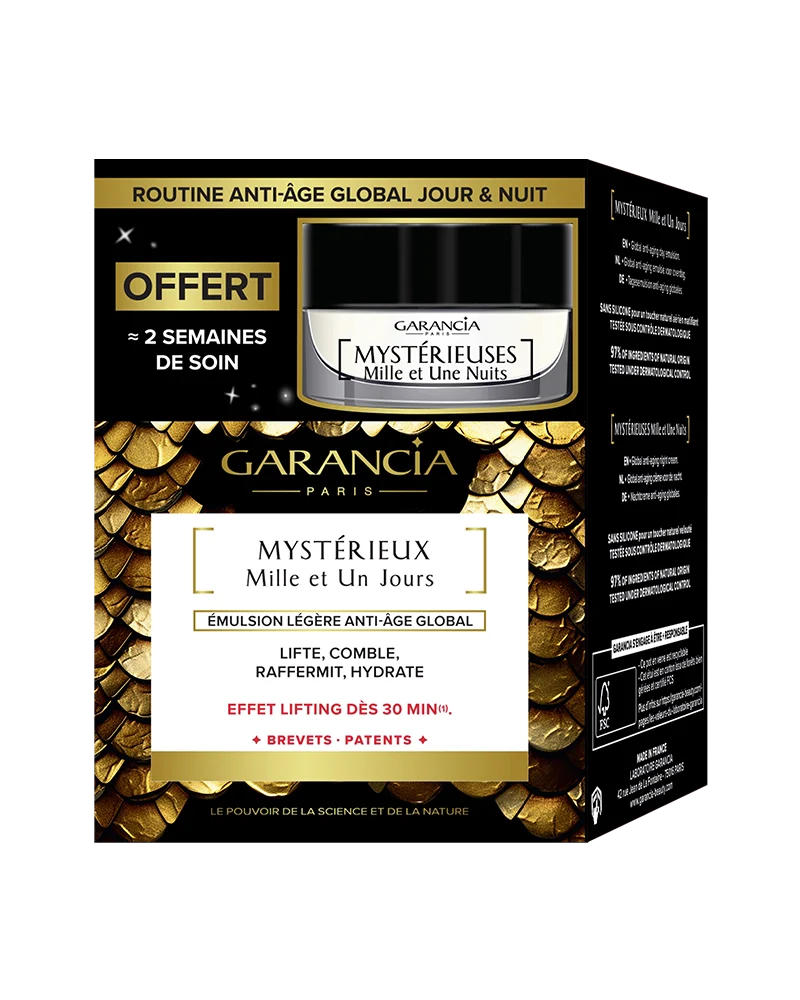 Embalaje de la caja dorada y negra que contiene el tarro de crema de día Mystérieux y una miniatura de noche gratis