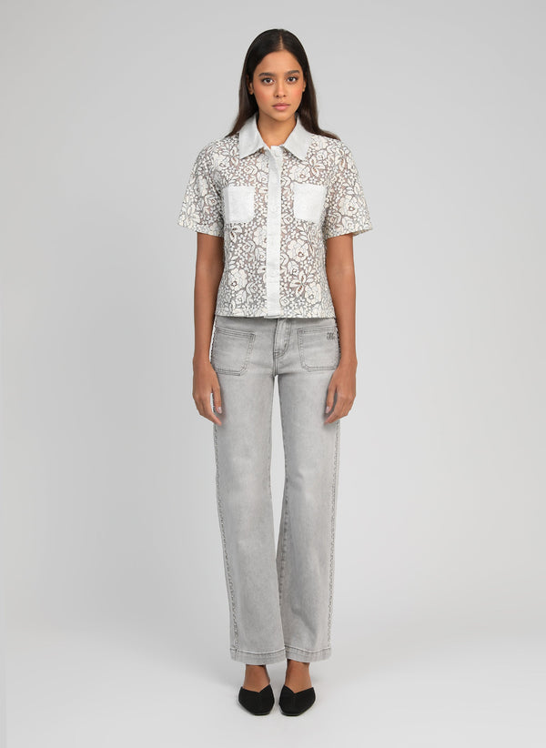 An'ge – Piclou Trousers Grey, model wearing a white lace shirt and light grey jeans