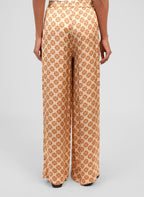 An'ge – Pantalon Presley Pirimini Ble, pantalon fluide à motif géométrique porté de dos par un mannequin