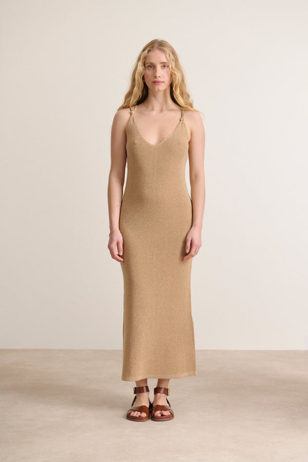 Close-fitting dress with delicate bows on the straps in a shimmering gold color dress that enhances the silhouette
