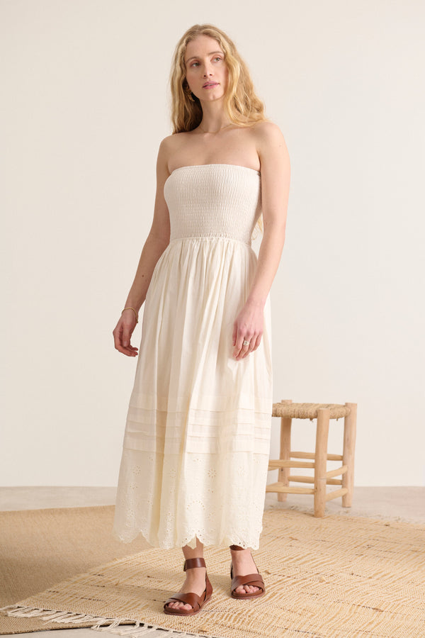English embroidery and delicate pleats enhance this ecru smocked dress, lined for absolute comfort.