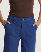 Ultramarine blue cotton pants with straight cut and rounded front pockets, offering stretchy comfort ideal for all female body shapes.