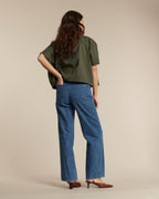 Women's jeans in medium blue cotton denim, straight cut offering an elegant and comfortable silhouette, suitable for all body shapes.