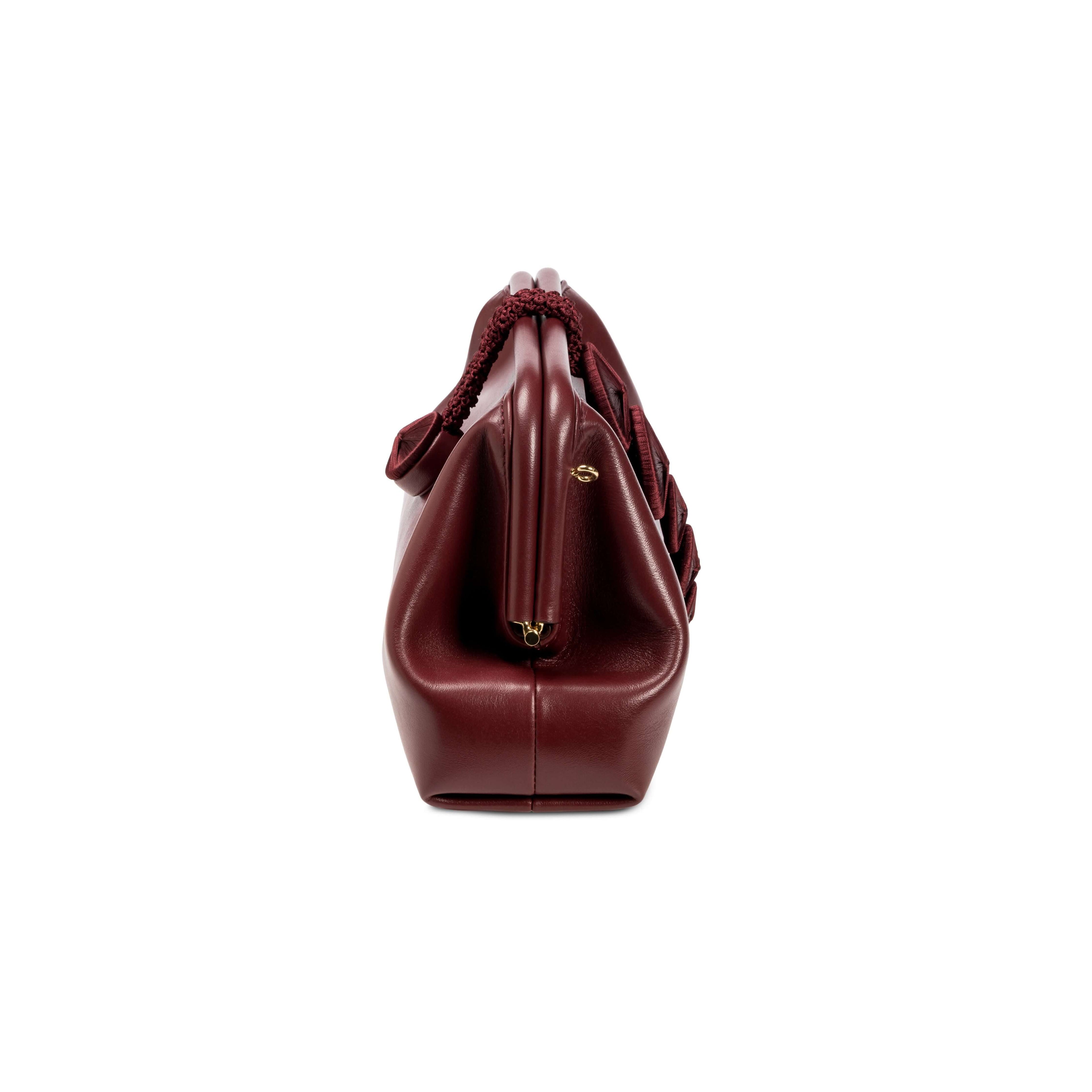 Alessa Burgundy Pouch Bag showcasing sleek design and high-quality materials, perfect for stylish outings.