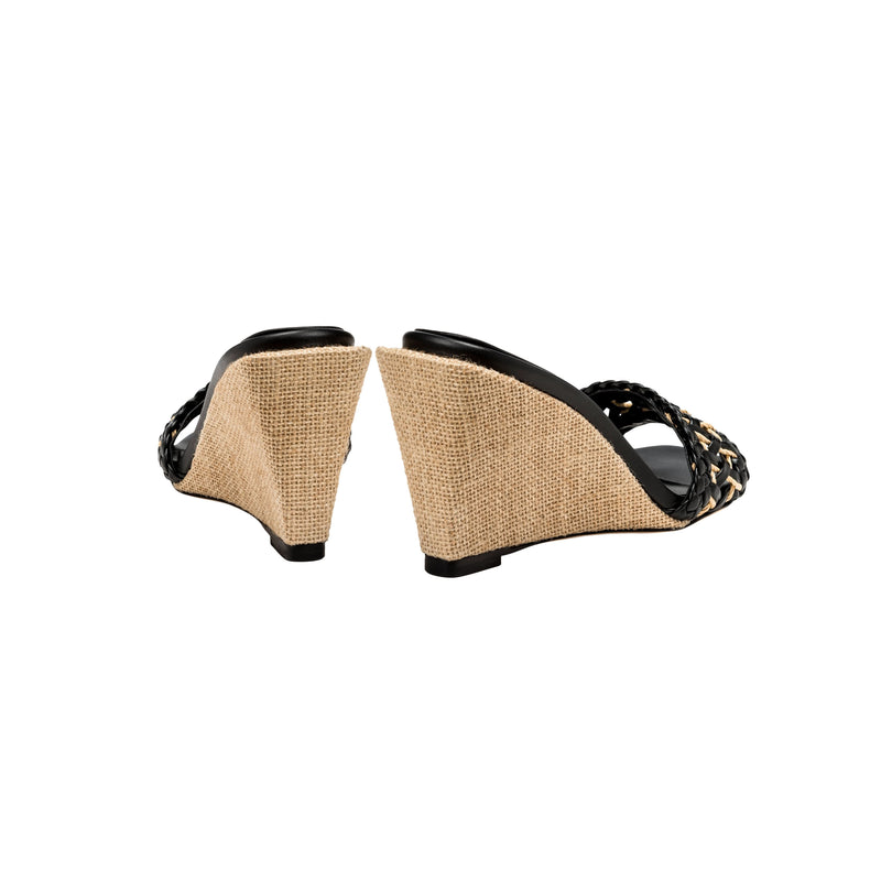 Stylish Almeria Black Wedge Sandal featuring a woven pattern and chic wedge heel design, perfect for summer fashion.