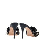 Sleek Aurnia black high-heel sandal with stylish woven design, showcasing elegant curves from the back view.