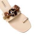 Delphine Nude Flat Toe Sandal with earth-colored beads and wide front strap, perfect for summer styling.