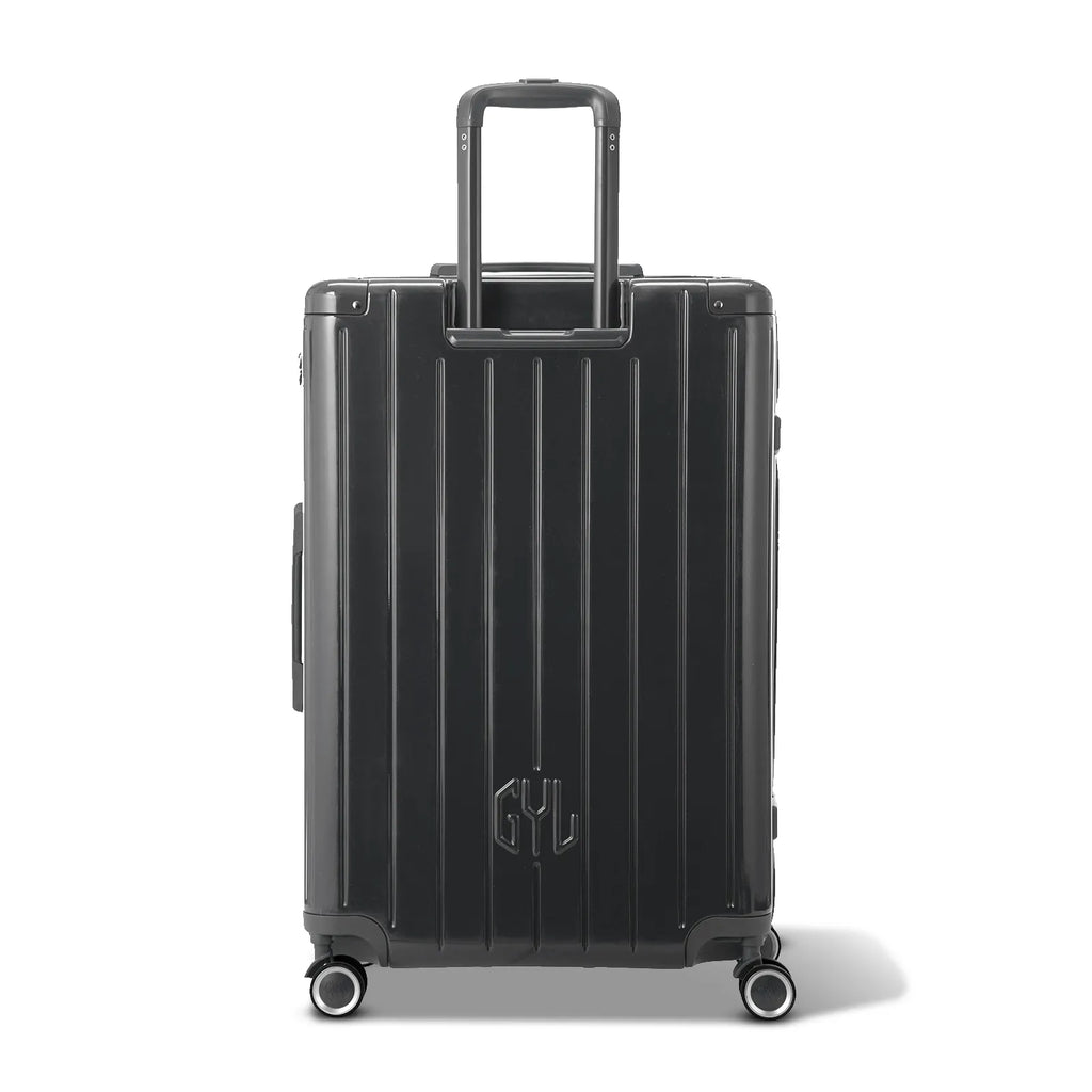 Rear view of the GYL Intemporelle black hard-shell suitcase with integrated handles and swivel wheels. #couleur_gris foncé