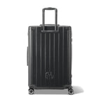 Rear view of the GYL Intemporelle black hard-shell suitcase with integrated handles and swivel wheels. #couleur_gris foncé