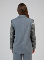 An'ge – Veste Howely Bleu, mannequin de dos portant un blazer gris à rayures avec manches à sequins