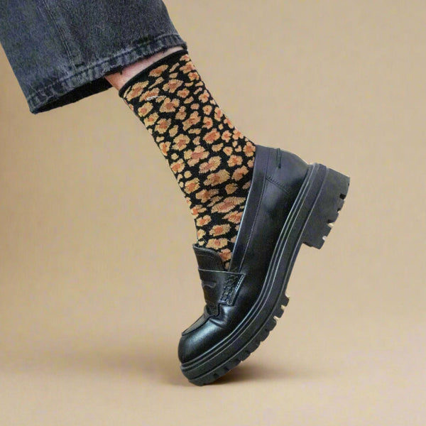 KLUE eco-friendly amber leopard socks styled with jeans and black leather shoes