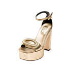 Naria Gold Platform Ankle Sandal featuring supple golden leather, bold oval embellishment, and 120mm platform heel.