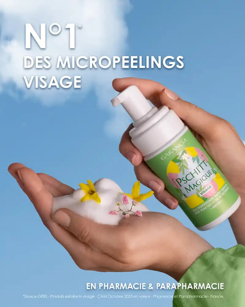 Using Pschitt Magique Garancia: one hand collects the creamy foam decorated with small yellow flowers, with the limited edition bottle against a background of blue spring sky.