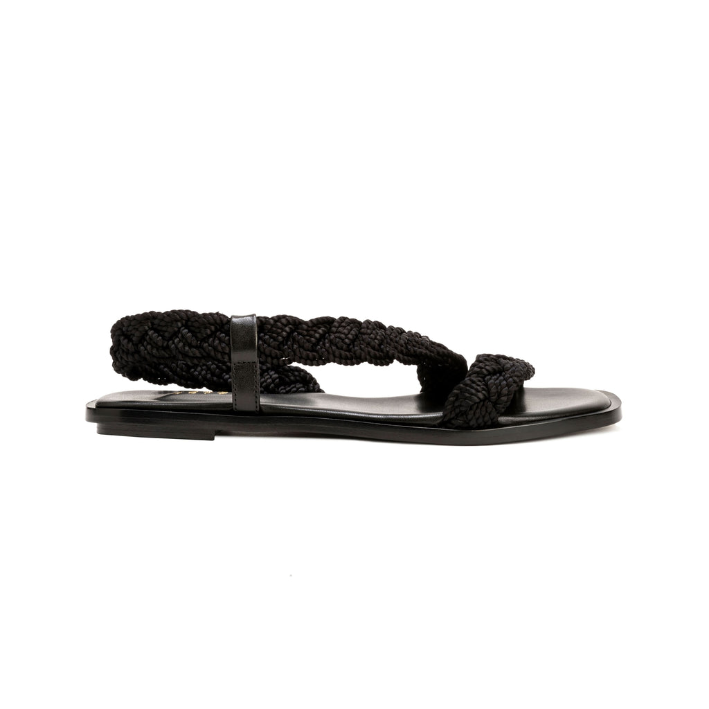Ronda Black Flat Asymmetric Sandal with braided straps and sleek leather sole, perfect for summer outfits.