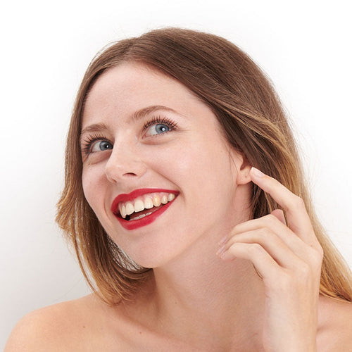 Couture red shade of natural and clean Pomponne lipstick on fair skin