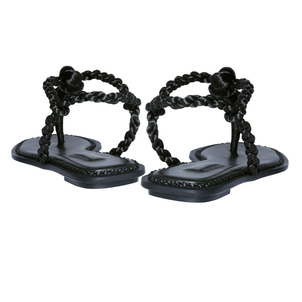 Thory Black Flat Sandal featuring braided metallic thread straps and a rich Italian leather sole for a casual yet elegant look.